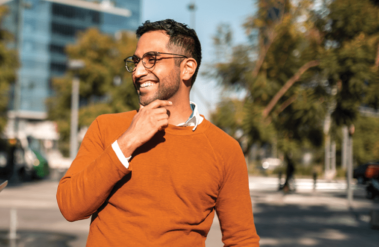 Two young people walking down the street and talking