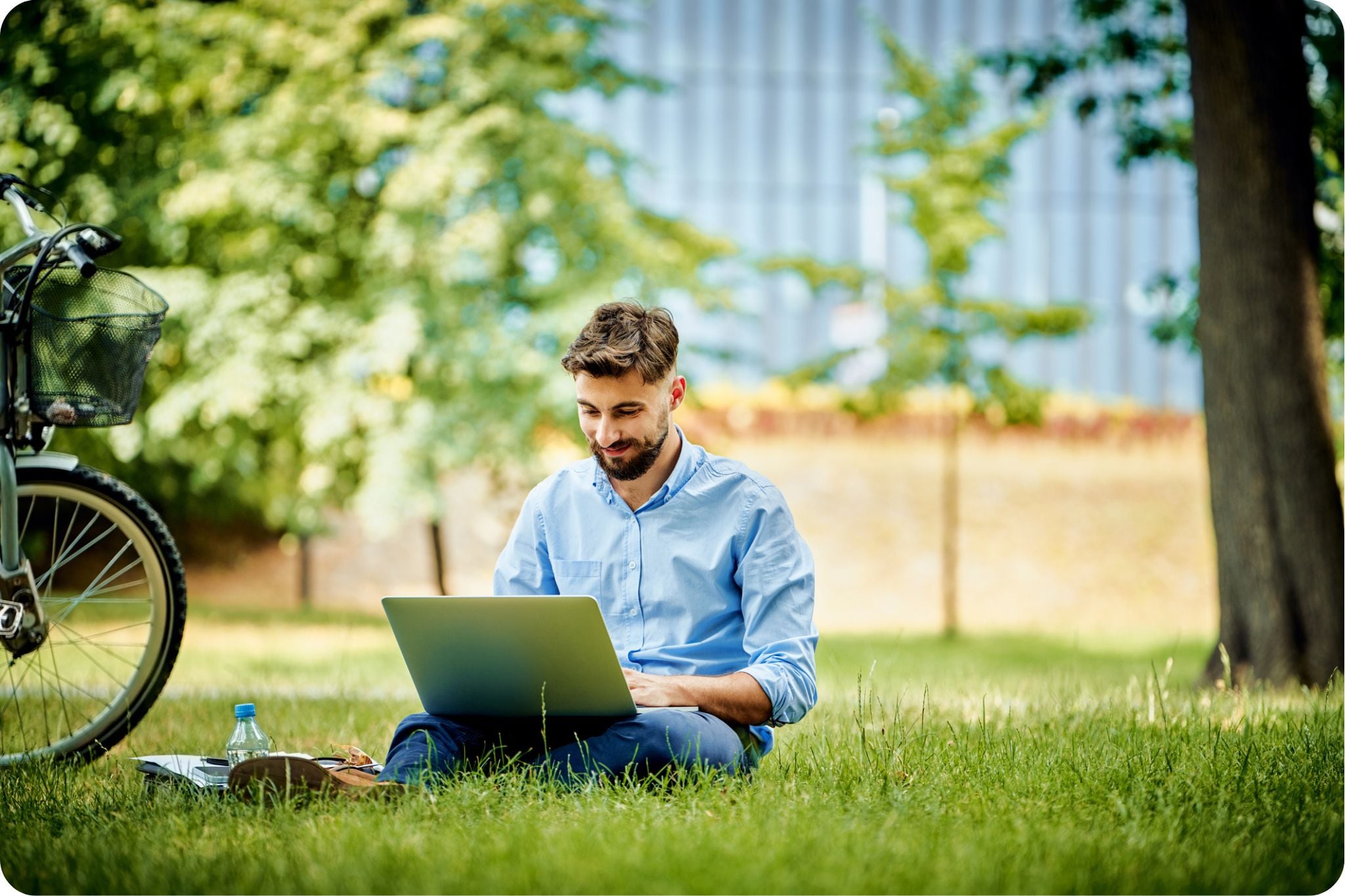 Man working on laptop at public park