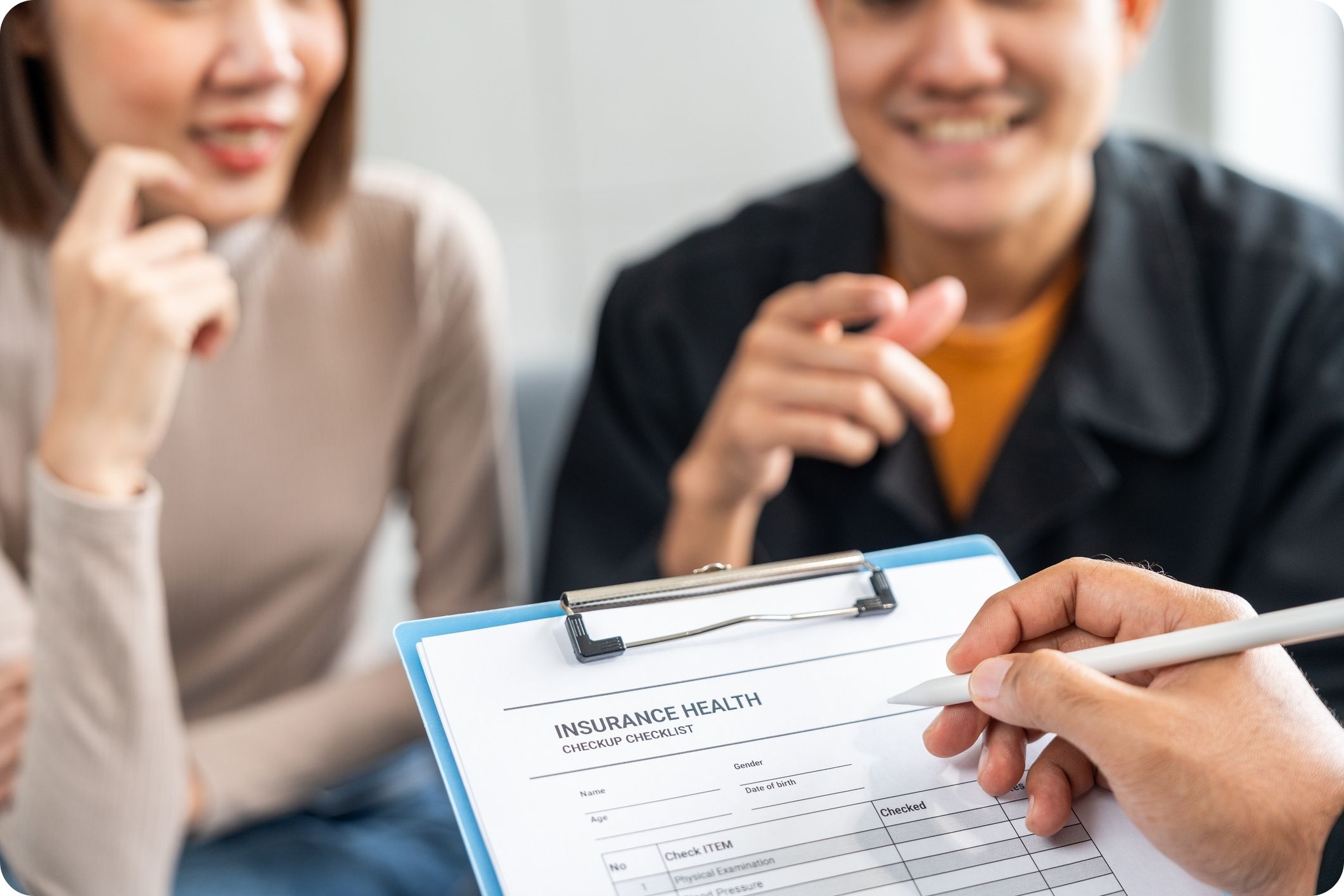 Expats discussing insurance health checkup form with advisor