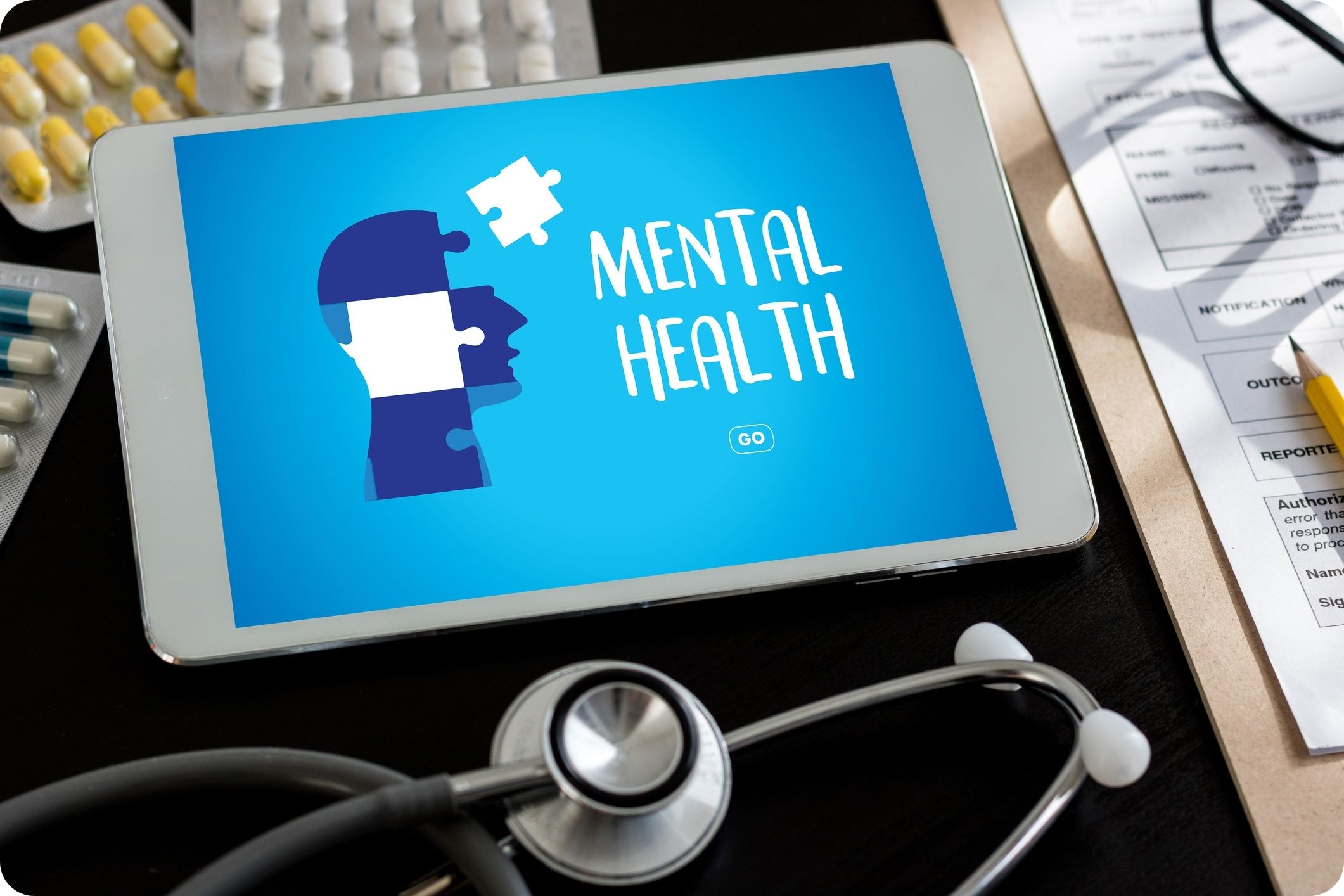 Mental health awareness graphic on tablet with stethoscope