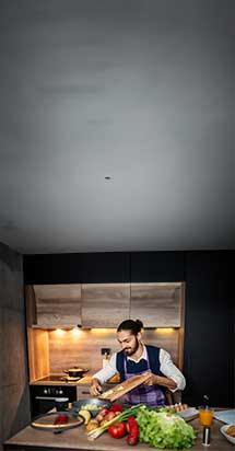 Young man preparing a vegetable meal in the kitchen, focusing on healthy eating habits and mindful food choices.