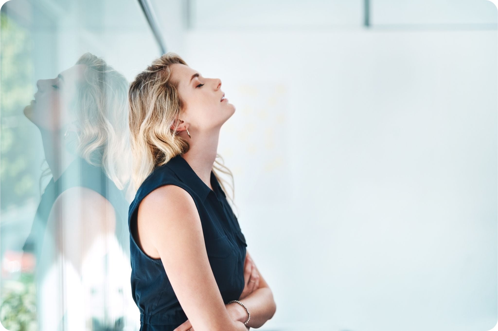 Young businesswoman looking stressed and fatigued while working in an office