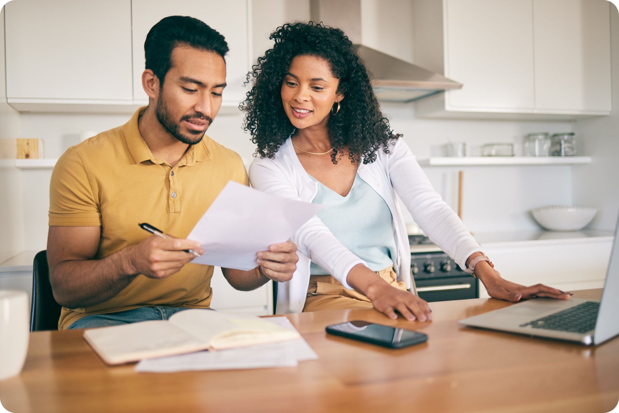 Young ouple reviewing documents at home together.
