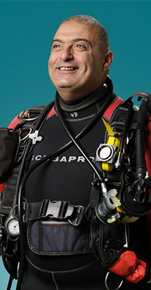 Middle-Aged deep sea diver excited to get ready for his adventurous swim.
