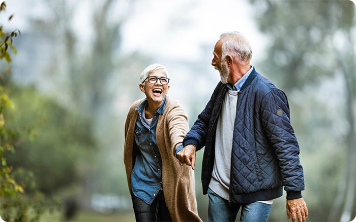 Young Asian woman sick with cancer using phone talk to friends sitting on sofa in living room at home.