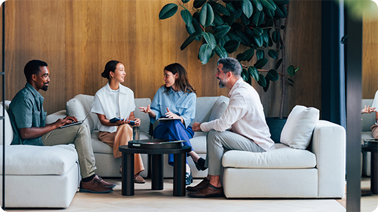 Global Underwriting: Coworkers discussing at the office rooftop.