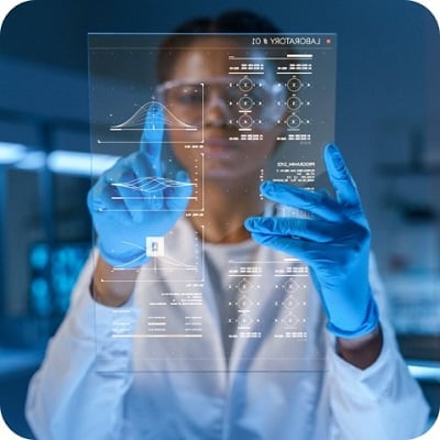 A young African - American doctor works on HUD or graphic display in front of her