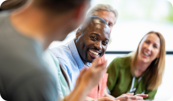 A close-up of a group of co-workers in a meeting