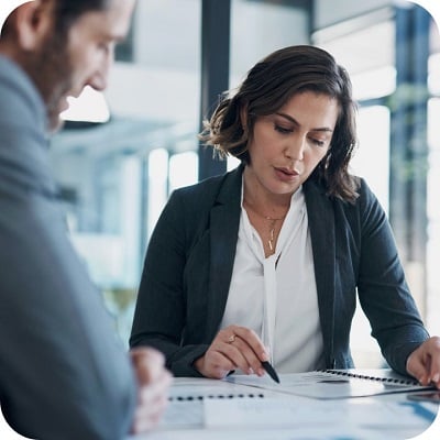 Woman and man sitting in office, going over a contract