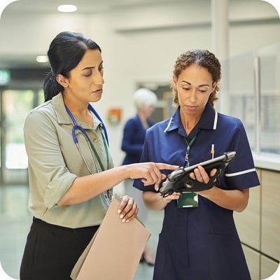 Hospital colleagues checking medical records database 