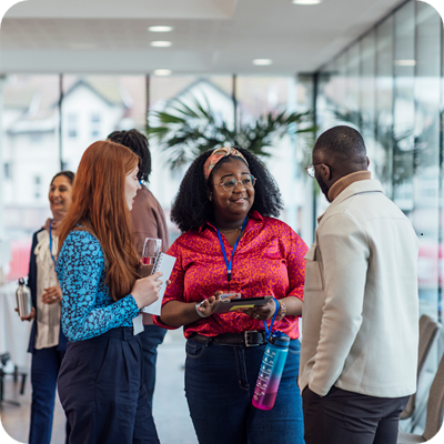 A wide angle view of a group of mixed age professionals who are taking advantage of a networking opportunity