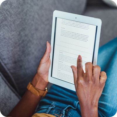 Shot of an unrecognisable woman using a digital tablet on the sofa at home
