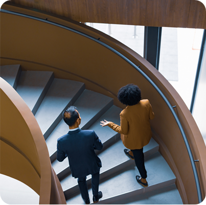 Business Colleagues Discussing on Spiral Staircase