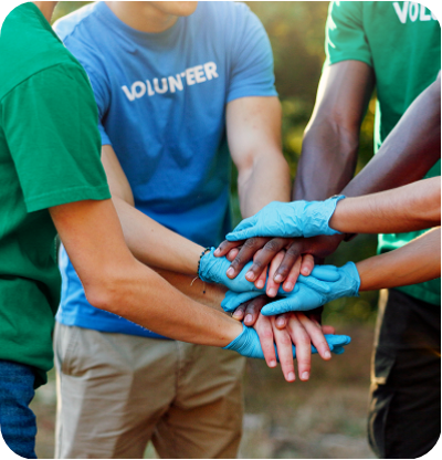 Group of volunteer stacking their hands, embracing teamwork