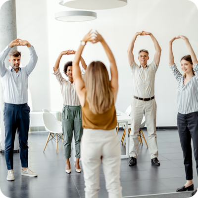 Businesspeople Doing Stretching Exercise at Workplace 