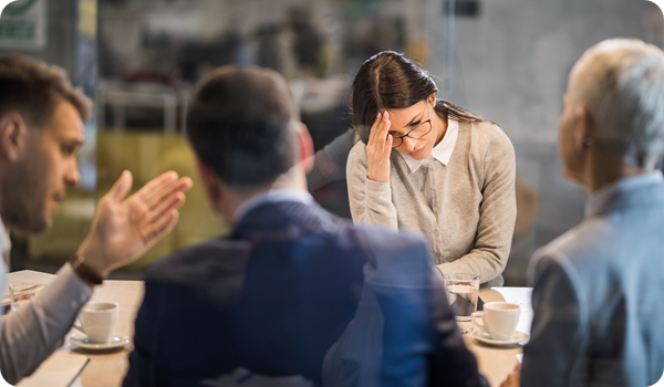 Young frustrated woman in a business meeting.
