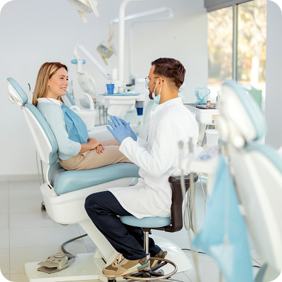 Dentist in dental office talking with a patient 