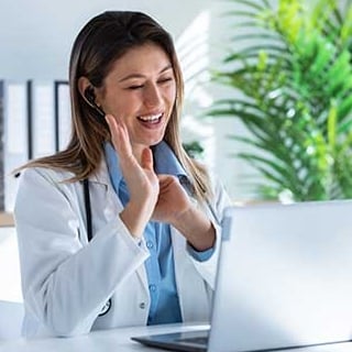 Female doctor consulting with a patient via video call on a laptop