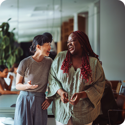 Coworkers Laughing Together During Office Break