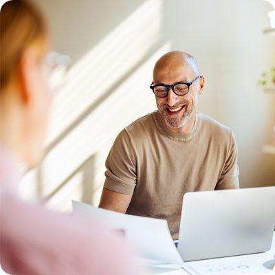 Smiling Man Having a Business Meeting in a Bright Office