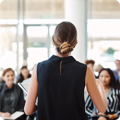 Shot of a young businesswoman delivering a speech during a training session