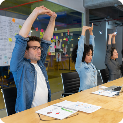 Workers doing stretching exercises in a business meeting at the office