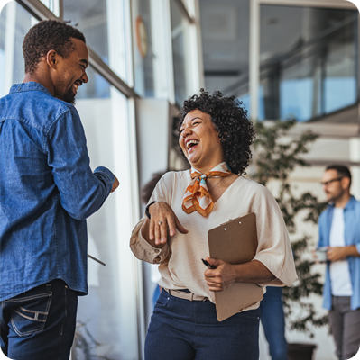 Colleagues Sharing a Laugh in a Modern Office Setting