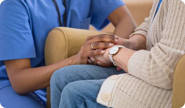 Home nurse taking care of senior woman