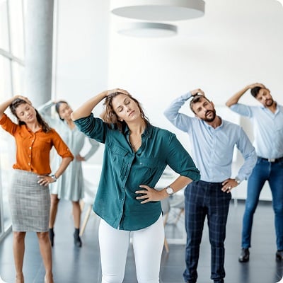 people in an office doing exercises