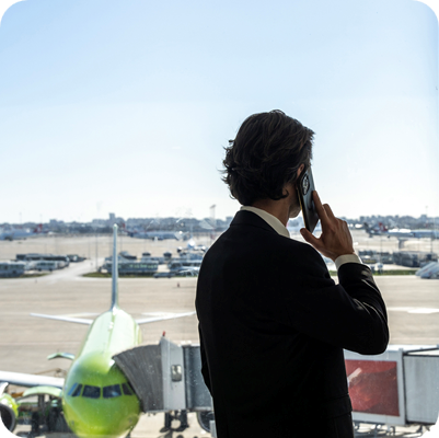 Businessman talking on phone at airport