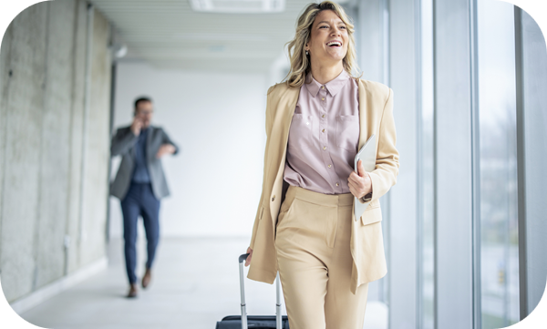 Businesswoman walking through airport during relocation abroad