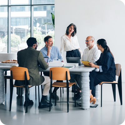 Professional Team Engaged in Discussion in Modern Office Meeting Room