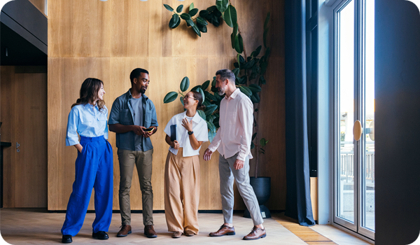 Group of Colleagues Socializing in a Modern and Bright Office Lobby 