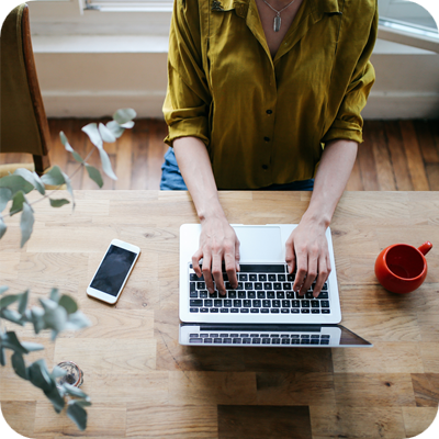 Overhead image of a female blogger writing on the laptop