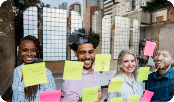 Diverse team brainstorming with post-it notes in office