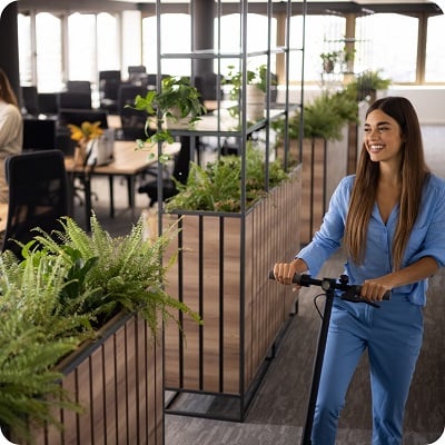 girl on a scooter arriving at office