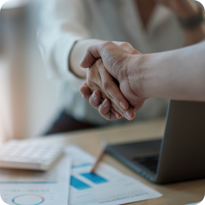 Two people shaking hands in an office environment
