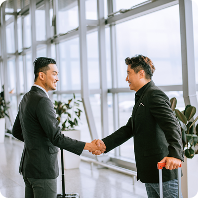 Business people shaking hands at airport