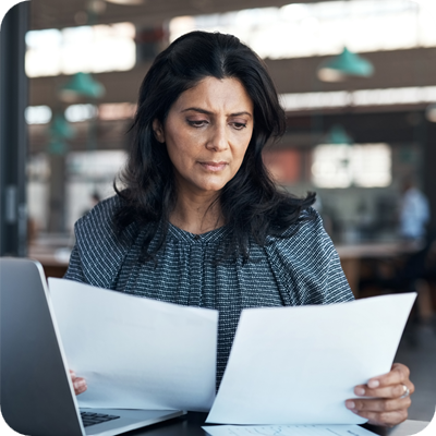 Business woman working on office policy at her desk
