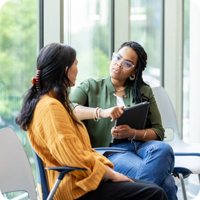 An empathetic female counselor listens as a vulnerable patient shares about a difficult situation.
