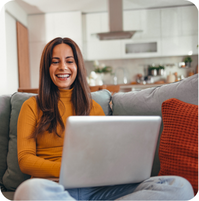 Woman working on laptop on sofa