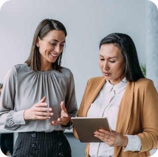 Two business women looking at an tablet