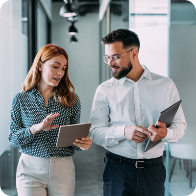 Shot of two coworkers having a discussion in modern office