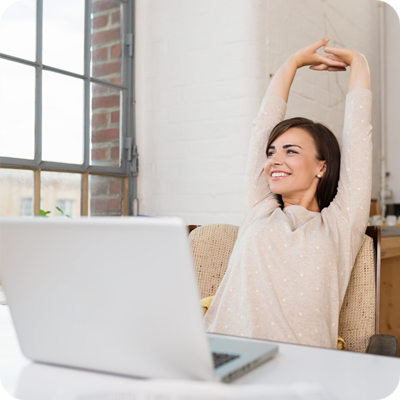Happy relaxed young woman sitting in her kitchen