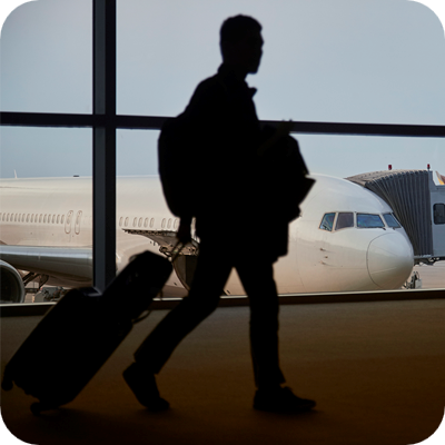 Passenger walking through airport terminal to aircraft 