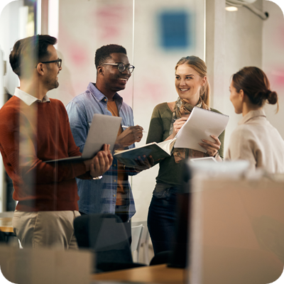 Happy multiracial business team having fun while talking during a meeting in the office.