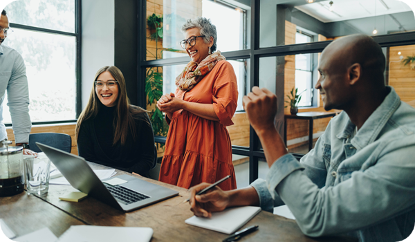 Diverse businesspeople smiling cheerfully during an office meeting