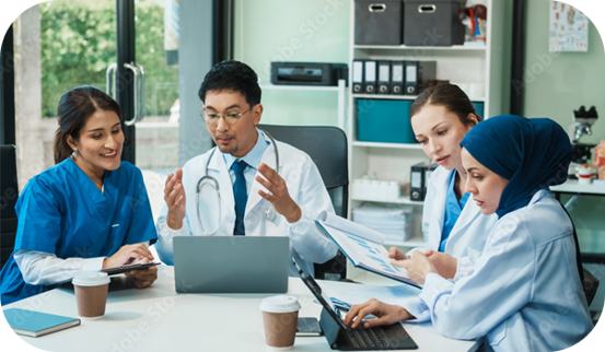 A diverse group of healthcare professionals collaborating around a table and through digital screens