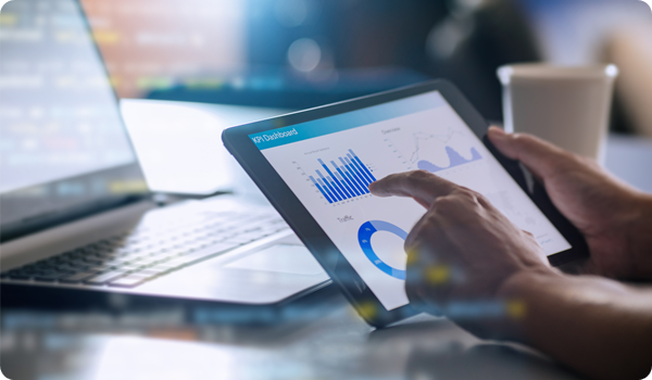 Business man holding a tablet, looking at KPIs
