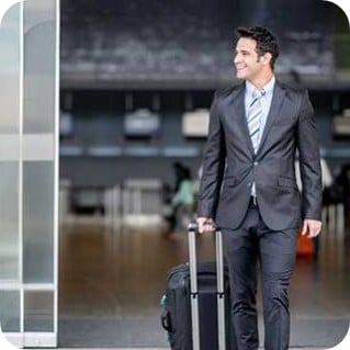Business man traveling and holding a suitcase at the airport